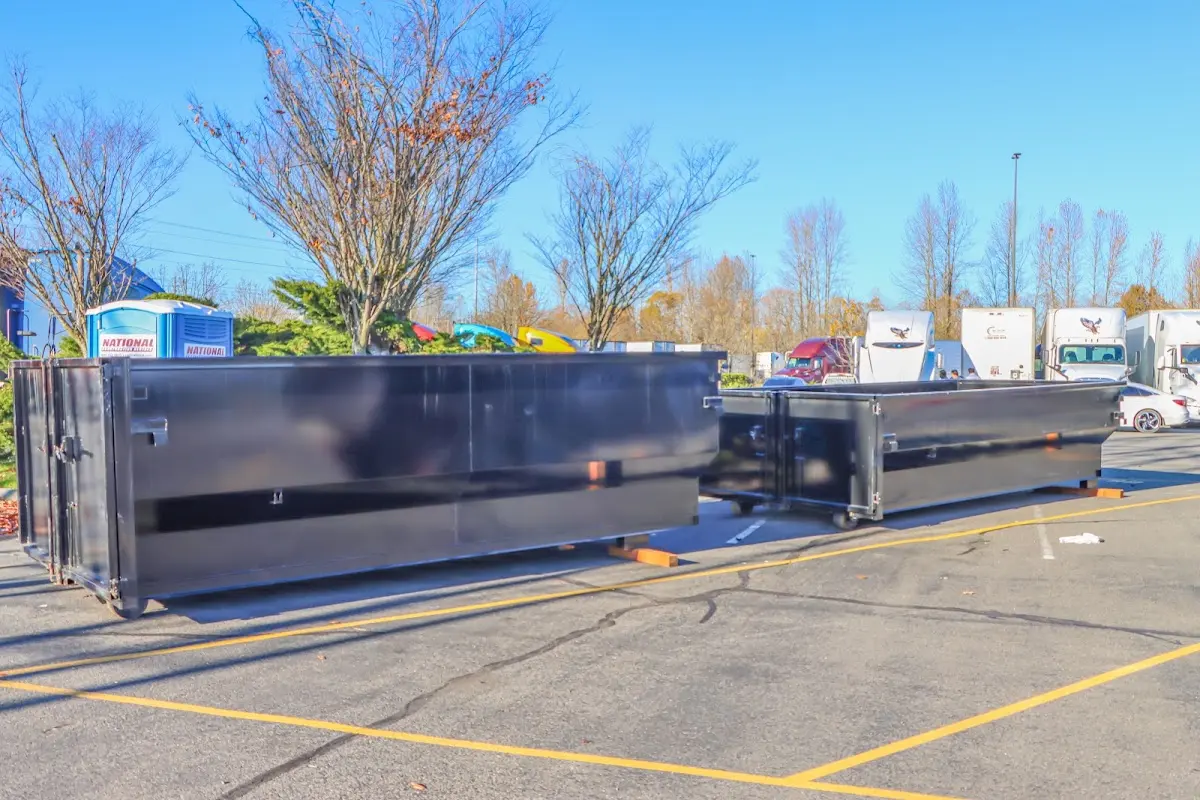 Professional dumpster rental service with roll-off container on residential driveway in Claverack